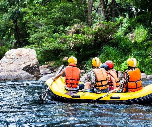 A group of men and women are rafting on the river, extreme and fun sport